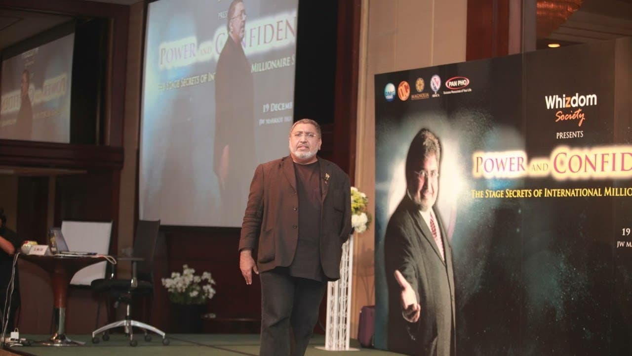 Dr Mel Gill speaking on stage at a Power and Confidence event